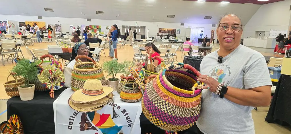 A vendor displays handwoven basket from Ghana