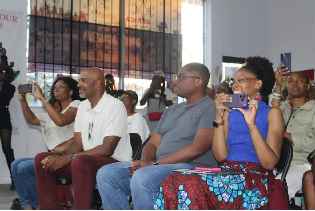 Parents watching their children perform at the summer camp showcase. Photo by Marion Apio