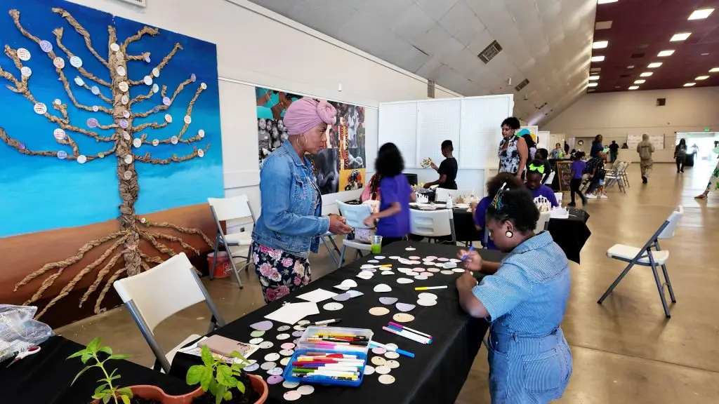 An attendee writes her intentions to be place on the 'Tree of Intentions' (Photo credit: Cecil Egbele)