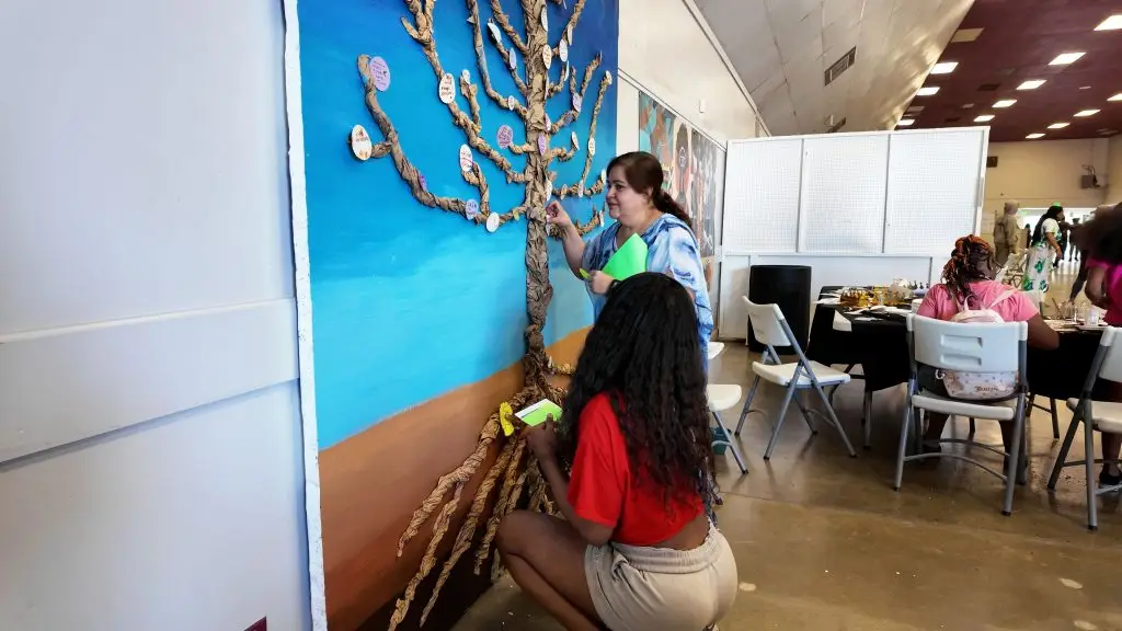 Attendees place their intentions on the 'Tree of Intentions' (Photo credit: Cecil Egbele)