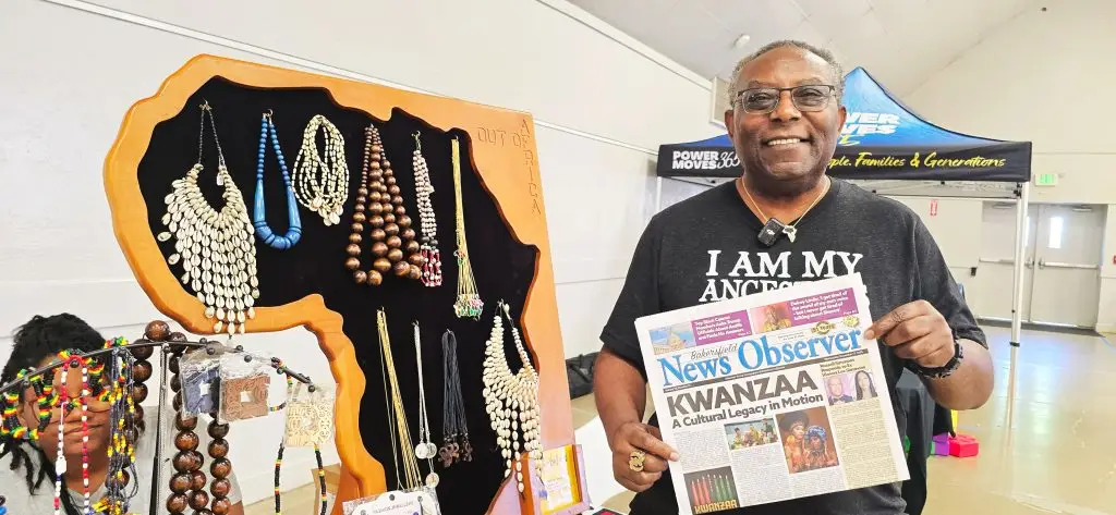 Sanyu Bakari, Director of Sankofa Collective poses with a copy of The Bakersfield News Observer (Photo credit: Cecil Egbele)