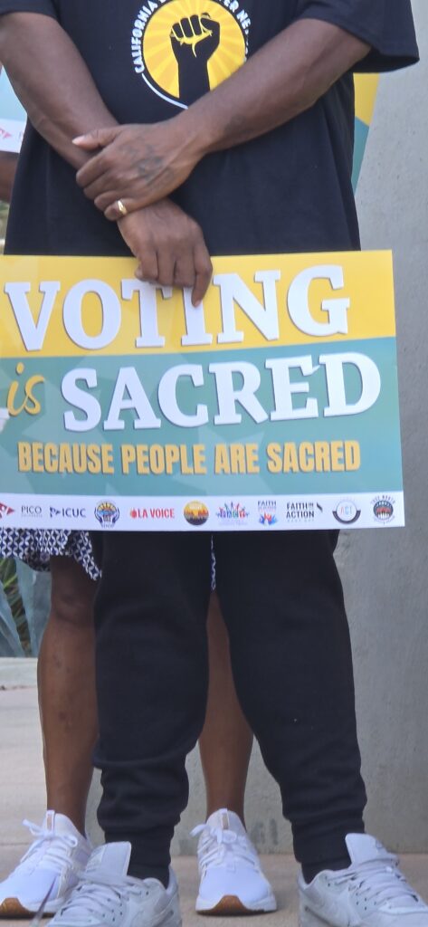 The campaign slogan, Voting is Sacred written on a placard (Photo Credit: Cecil Egbele)